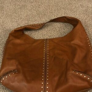 Michael Kors studded brown bucket bag.
